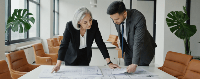 Architects review blueprints on table.